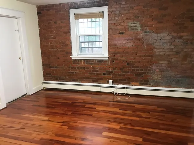 a view of a livingroom with wooden floor