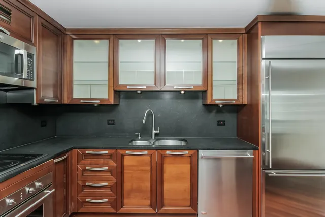 a kitchen with stainless steel appliances granite countertop a sink and a granite counter tops