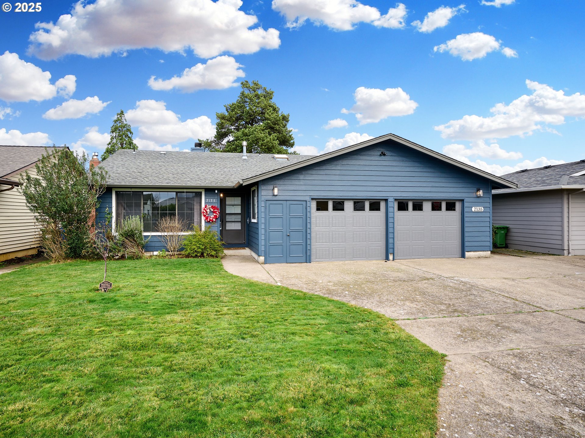 2135 Country Club Terrace Woodburn, OR 97071 - Photo 1 of 36 a front view of a house with a yard and garage