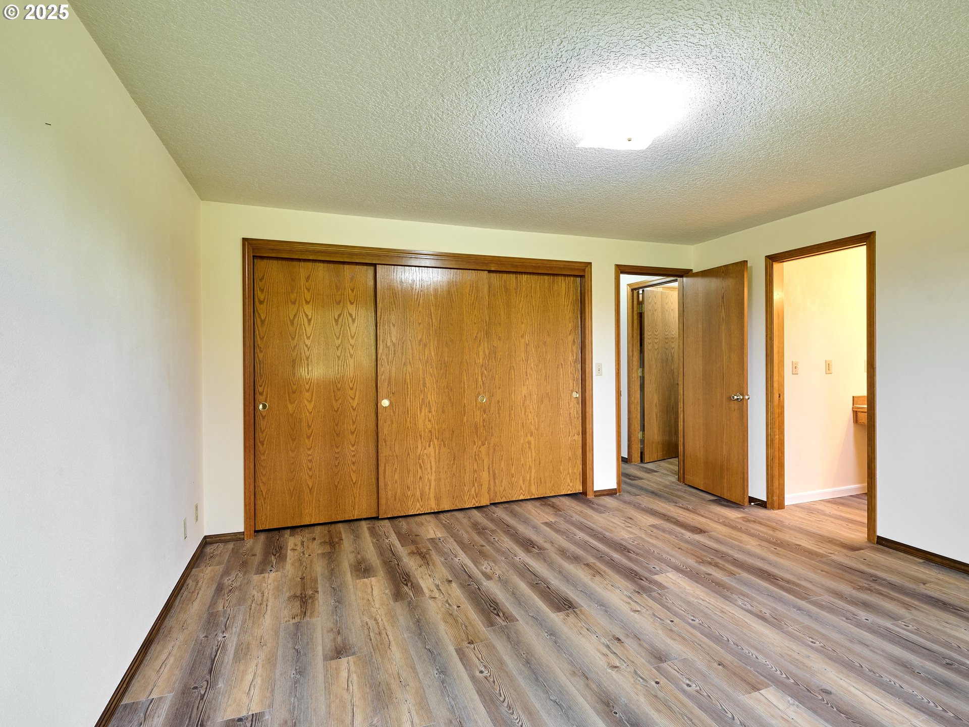 2135 Country Club Terrace Woodburn, OR 97071 - Photo 13 of 36 an empty room with wooden floor and windows