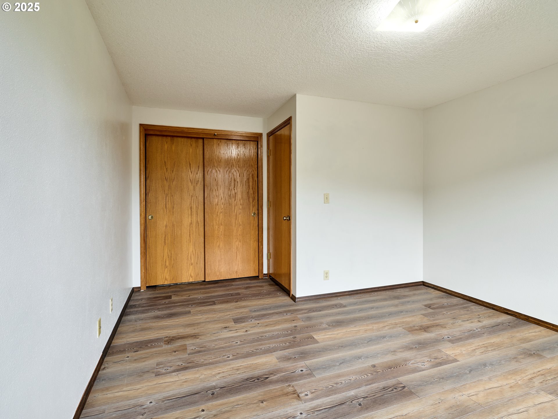 2135 Country Club Terrace Woodburn, OR 97071 - Photo 16 of 36 a view of an empty room with wooden floor