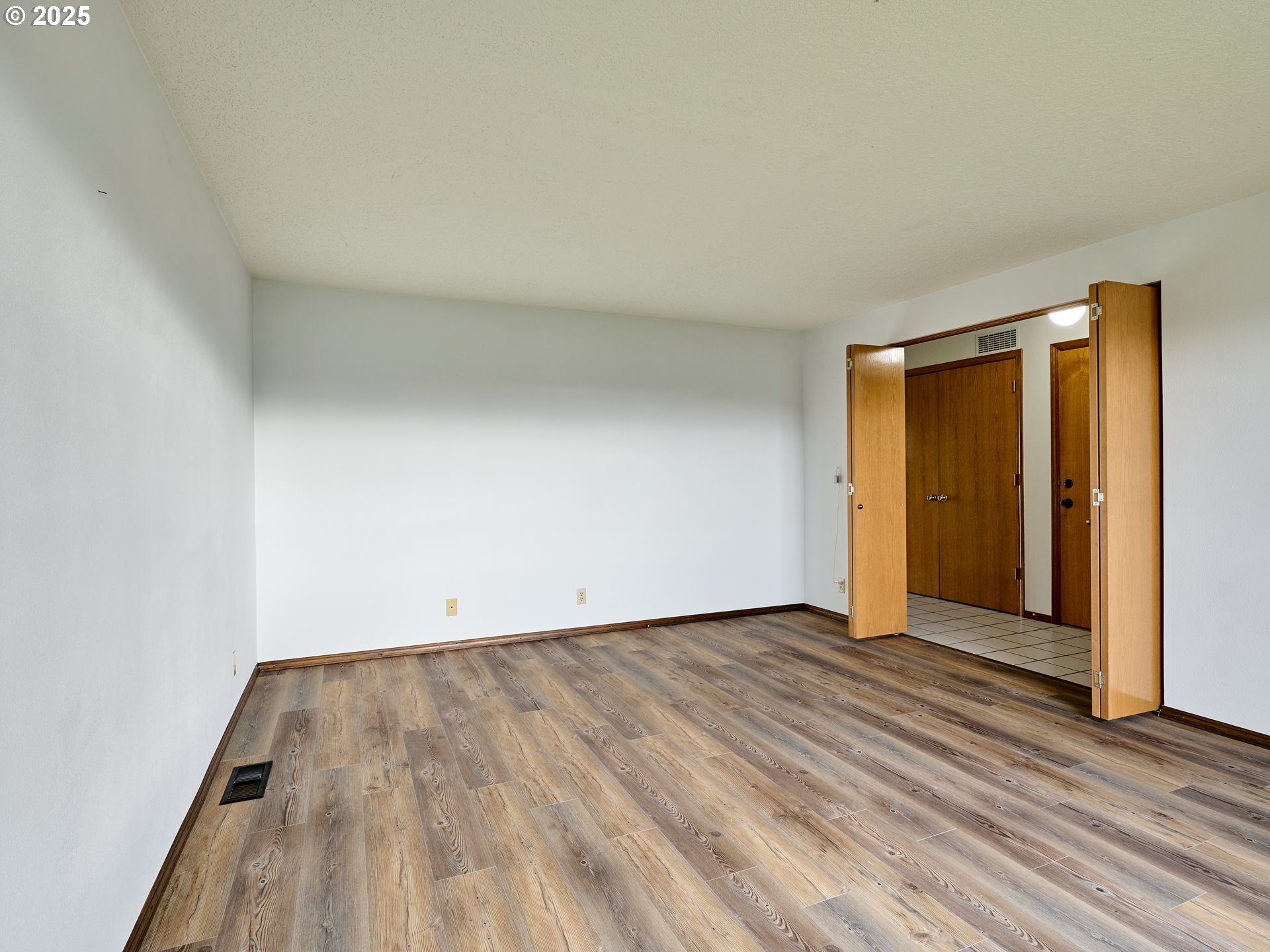 2135 Country Club Terrace Woodburn, OR 97071 - Photo 4 of 36 an empty room with wooden floor and closet