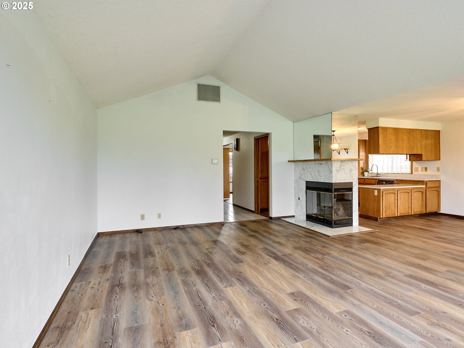 2135 Country Club Terrace Woodburn, OR 97071 - Photo 6 of 36 a view of a kitchen with wooden floor electronic appliances and stairs