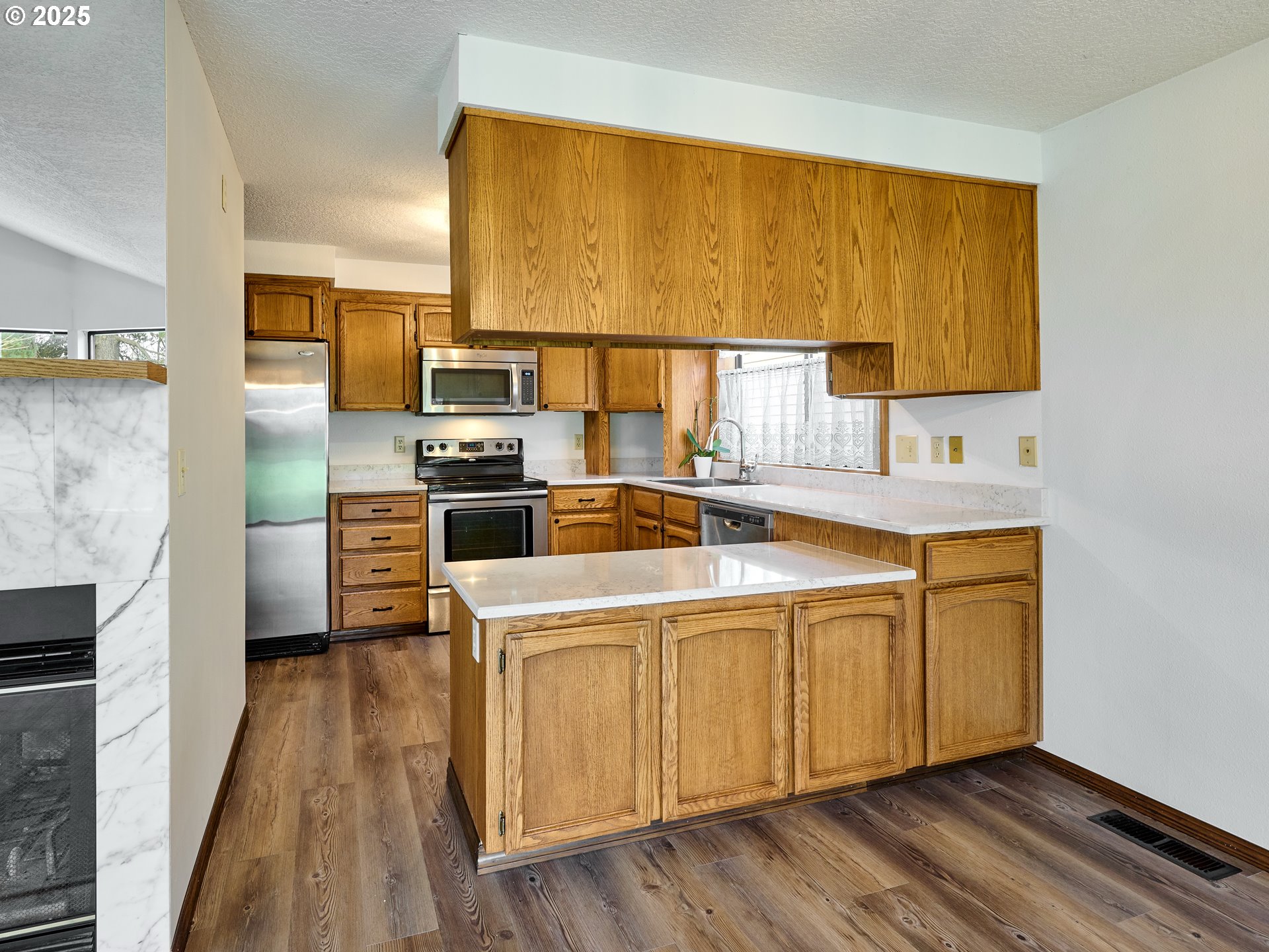 2135 Country Club Terrace Woodburn, OR 97071 - Photo 9 of 36 a kitchen with a sink stove and refrigerator