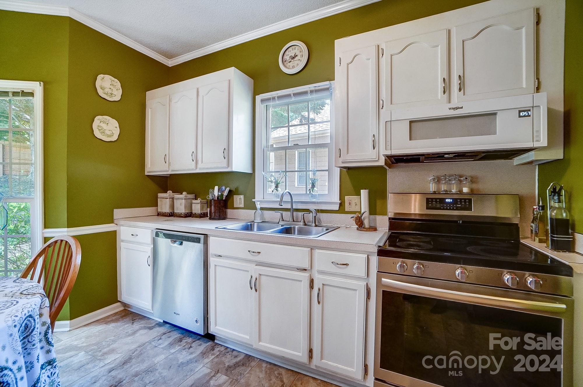 3063 River Ridge Drive Gastonia, NC 28056 - Photo 14 of 42 a kitchen with stainless steel appliances granite countertop a stove a sink and a microwave