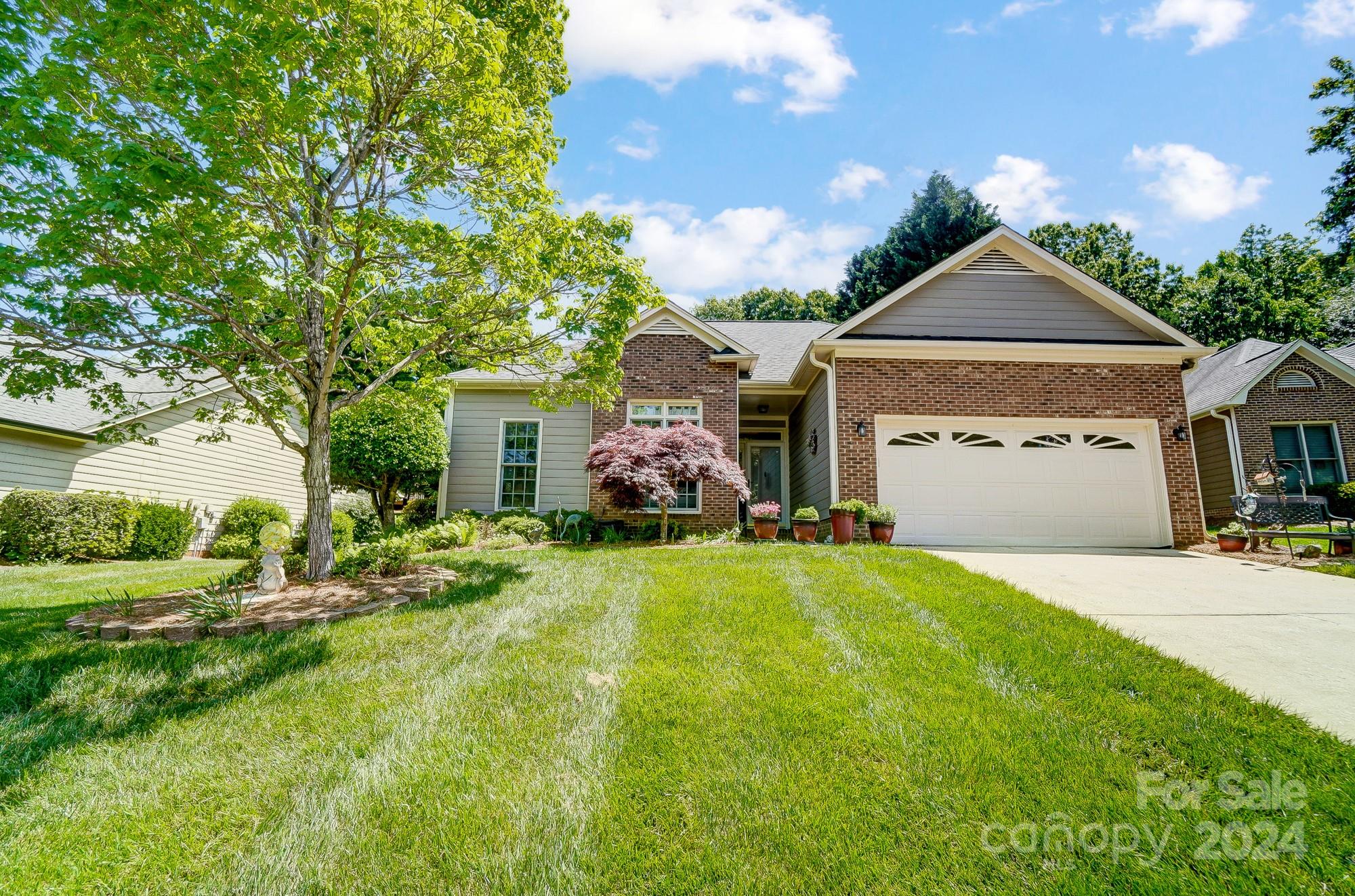 3063 River Ridge Drive Gastonia, NC 28056 - Photo 2 of 42 a front view of a house with a yard and garage