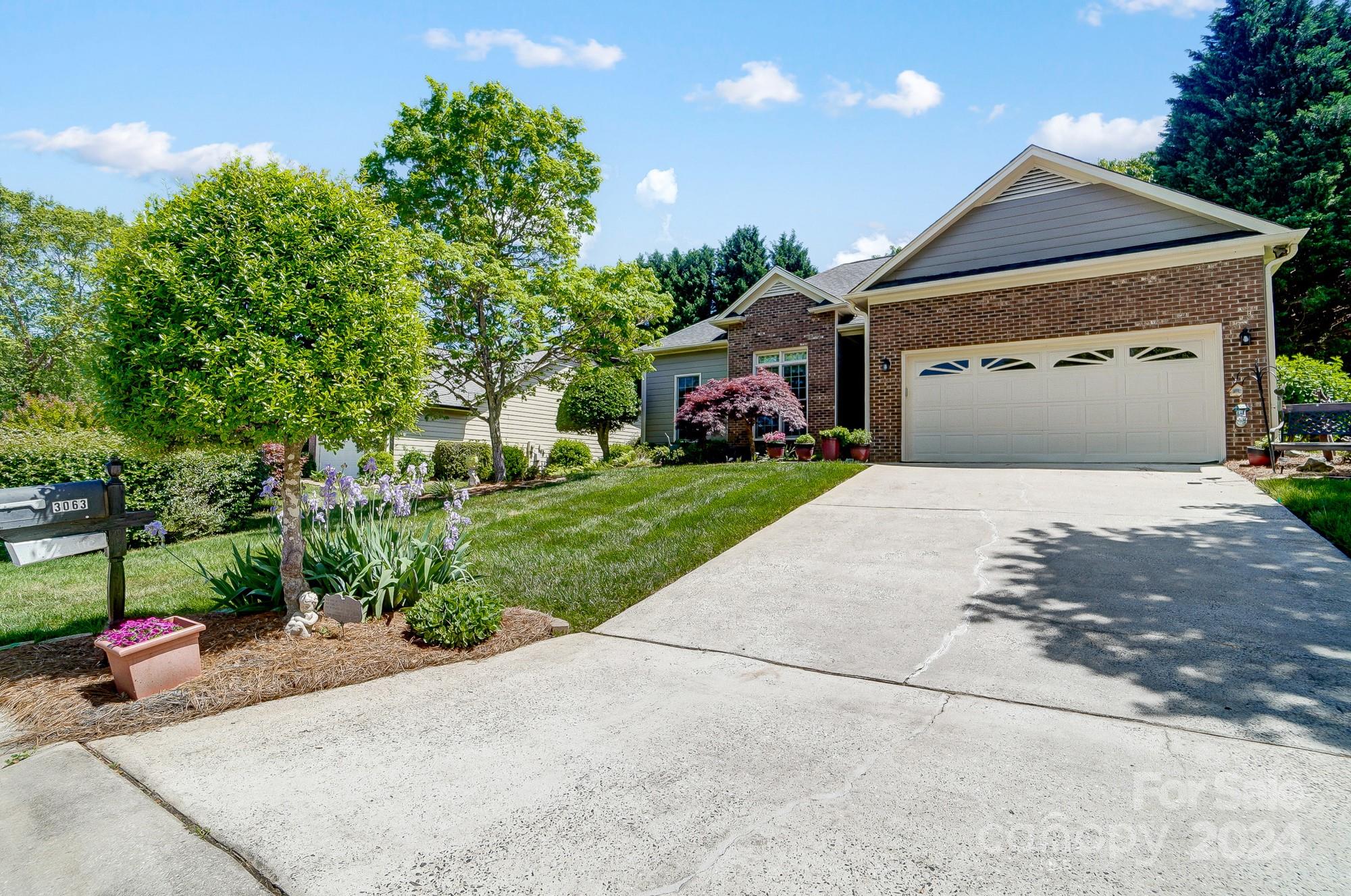 3063 River Ridge Drive Gastonia, NC 28056 - Photo 4 of 42 a front view of a house with a yard and garage