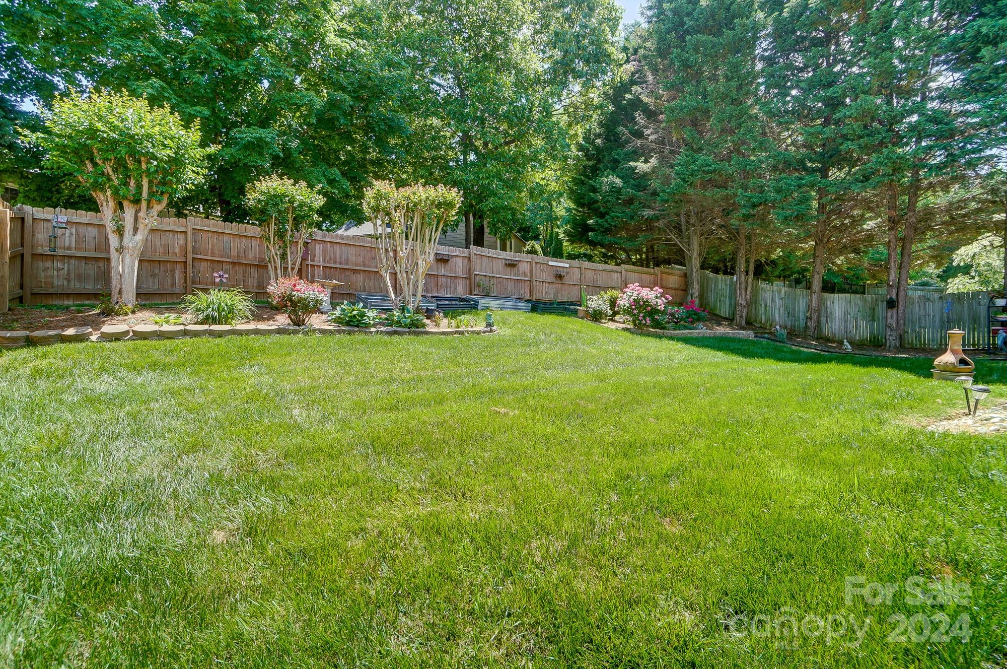 3063 River Ridge Drive Gastonia, NC 28056 - Photo 42 of 42 a view of a backyard with a garden and trees