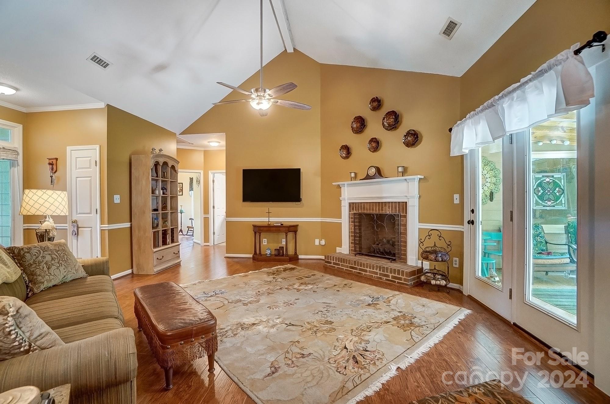 3063 River Ridge Drive Gastonia, NC 28056 - Photo 10 of 42 a living room with furniture a flat screen tv and a fireplace