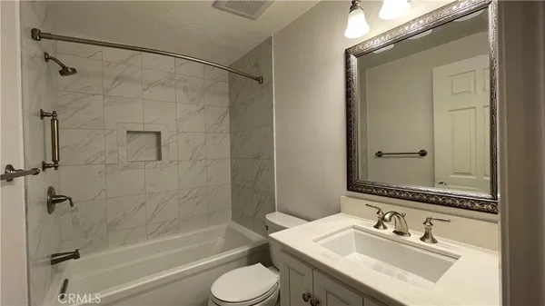 a bathroom with a sink toilet tub and shower