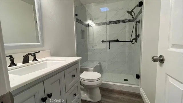 a bathroom with a sink toilet and shower
