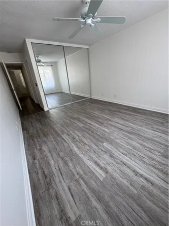wooden floor in an empty room with a mirror