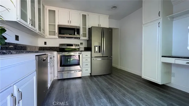 a kitchen with stainless steel appliances a refrigerator stove and microwave