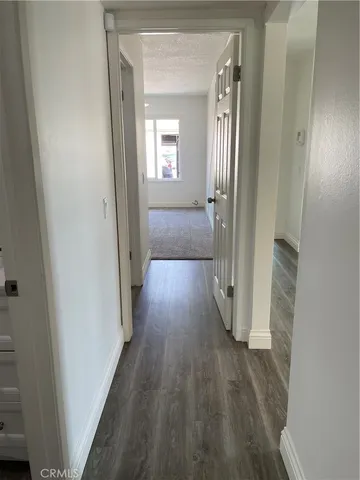 a view of a hallway with wooden floor