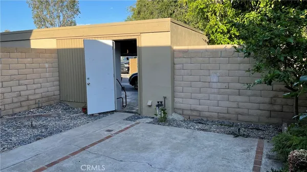 a view of a small house with a small yard