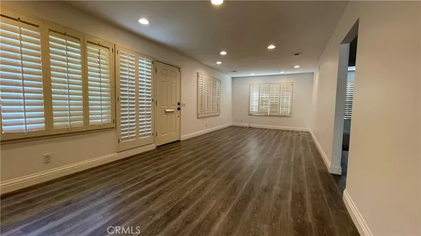 a view of a room with wooden floor and window