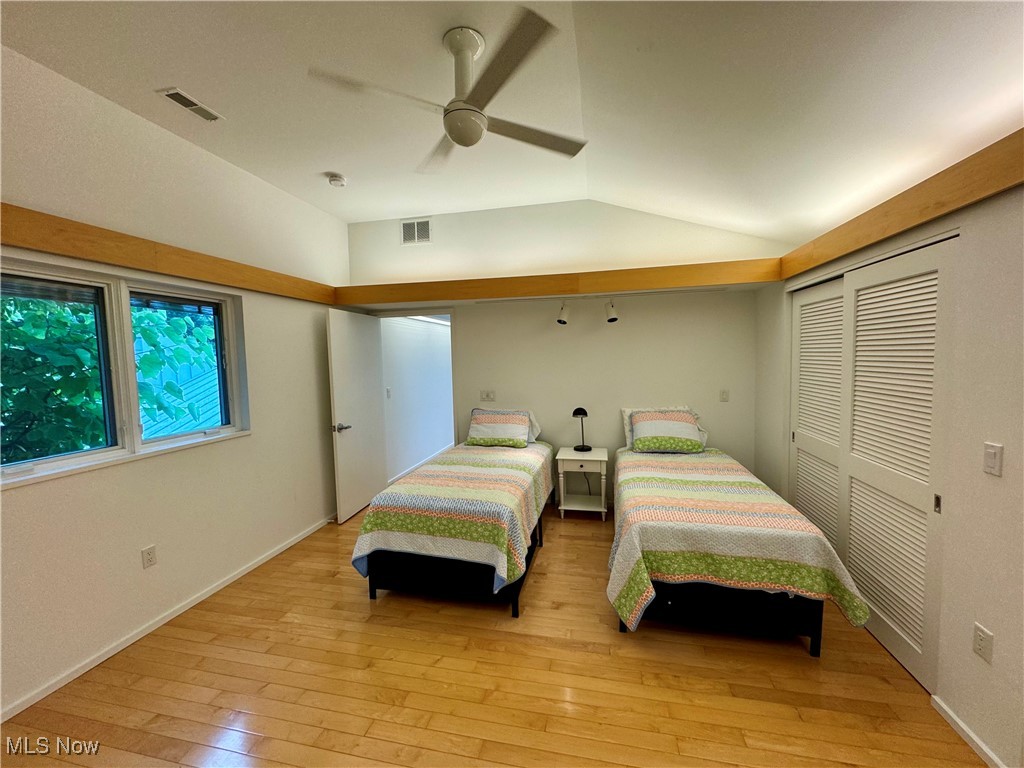 3559 Birchtree Path Cleveland, OH 44121 - Photo 22 of 37 Bedroom with light wood-style flooring, vaulted ceiling, a closet, and a ceiling fan