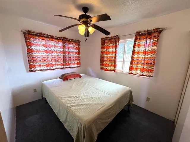 a bedroom with a bed and window