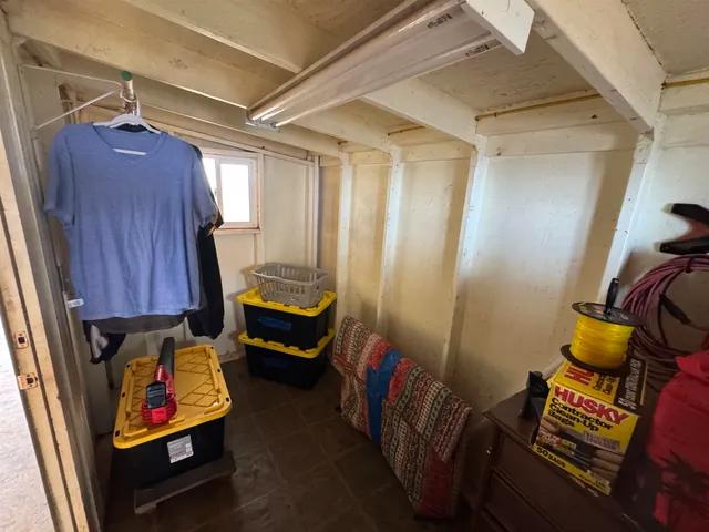 a bedroom with furniture and a window