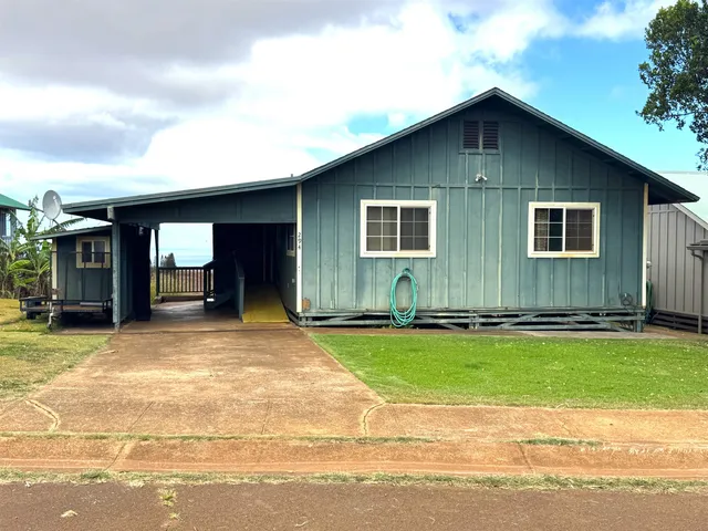 a view of a house with a yard and garage