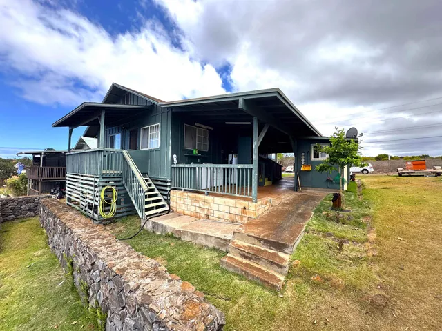 a view of a house with swimming pool and sitting area