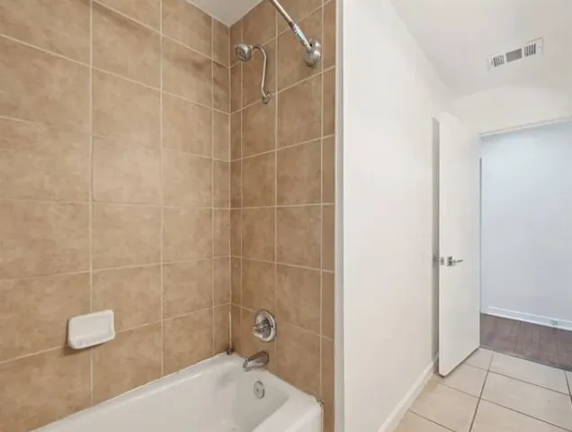 a bathroom with a bathtub and shower
