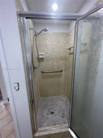 a bathroom with a glass shower door