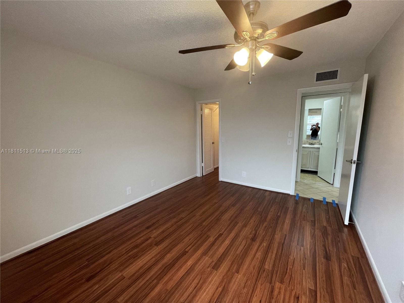 413 Saxony Way, Unit 413 Delray Beach, FL 33446 - Photo 4 of 14 wooden floor in an empty room with a window