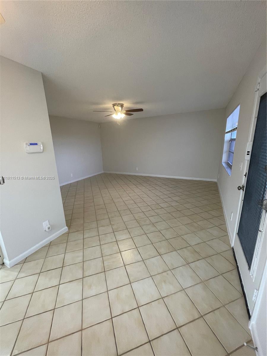 413 Saxony Way, Unit 413 Delray Beach, FL 33446 - Photo 9 of 14 an empty room with windows