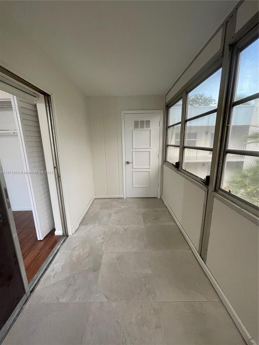 413 Saxony Way, Unit 413 Delray Beach, FL 33446 - Photo 10 of 14 a view of an empty room with a window