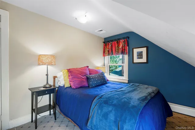 a bedroom with a bed and a lamp