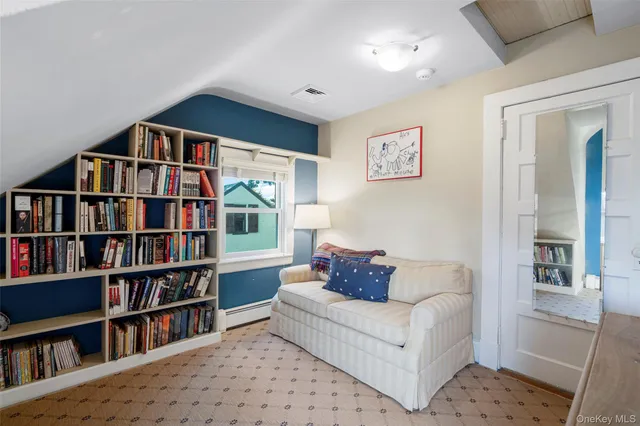 a living room with a couch and a book shelf