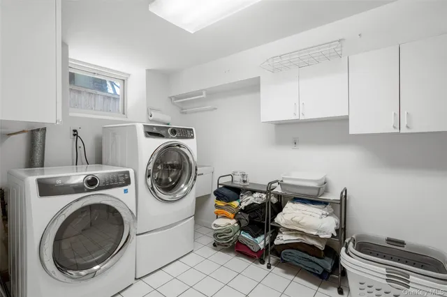 a utility room with sink dryer and washer