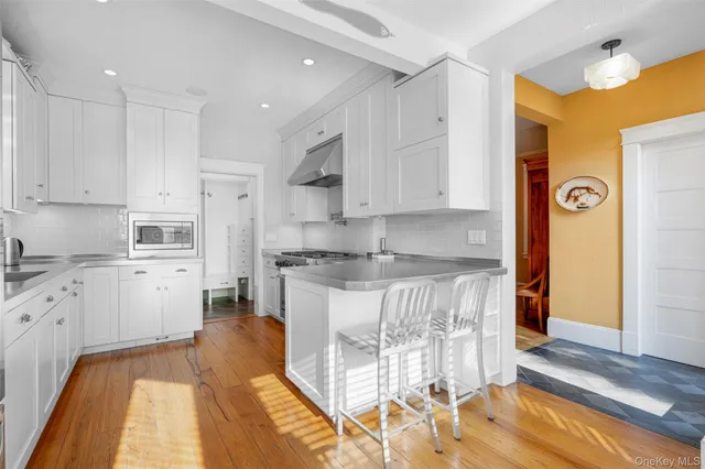 a kitchen with granite countertop a stove a sink and a refrigerator