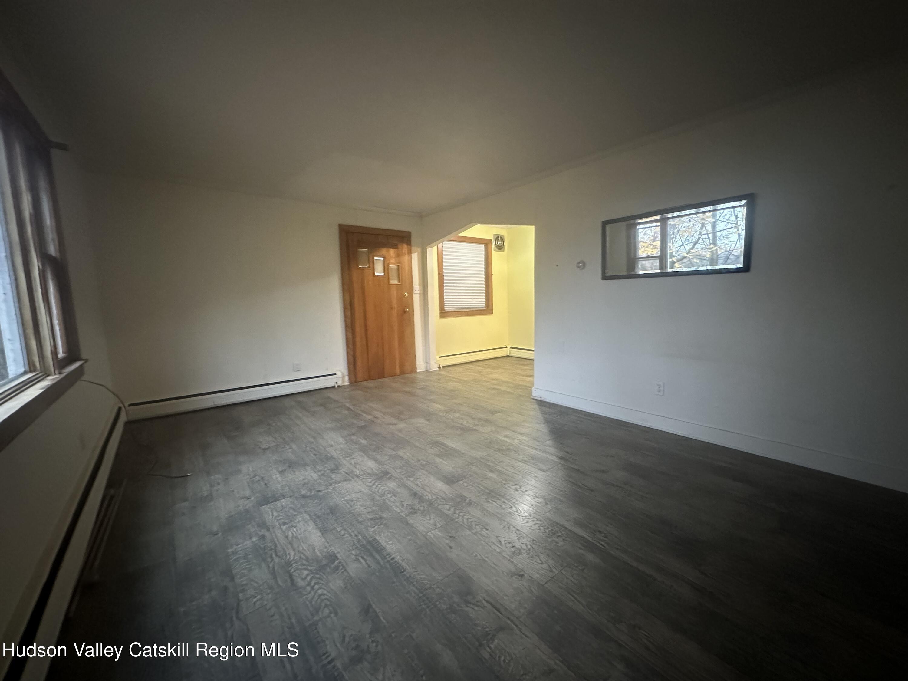 6140 Highway 9G, Unit 4 Hudson, NY 12534 - Photo 4 of 9 an empty room with wooden floor and windows
