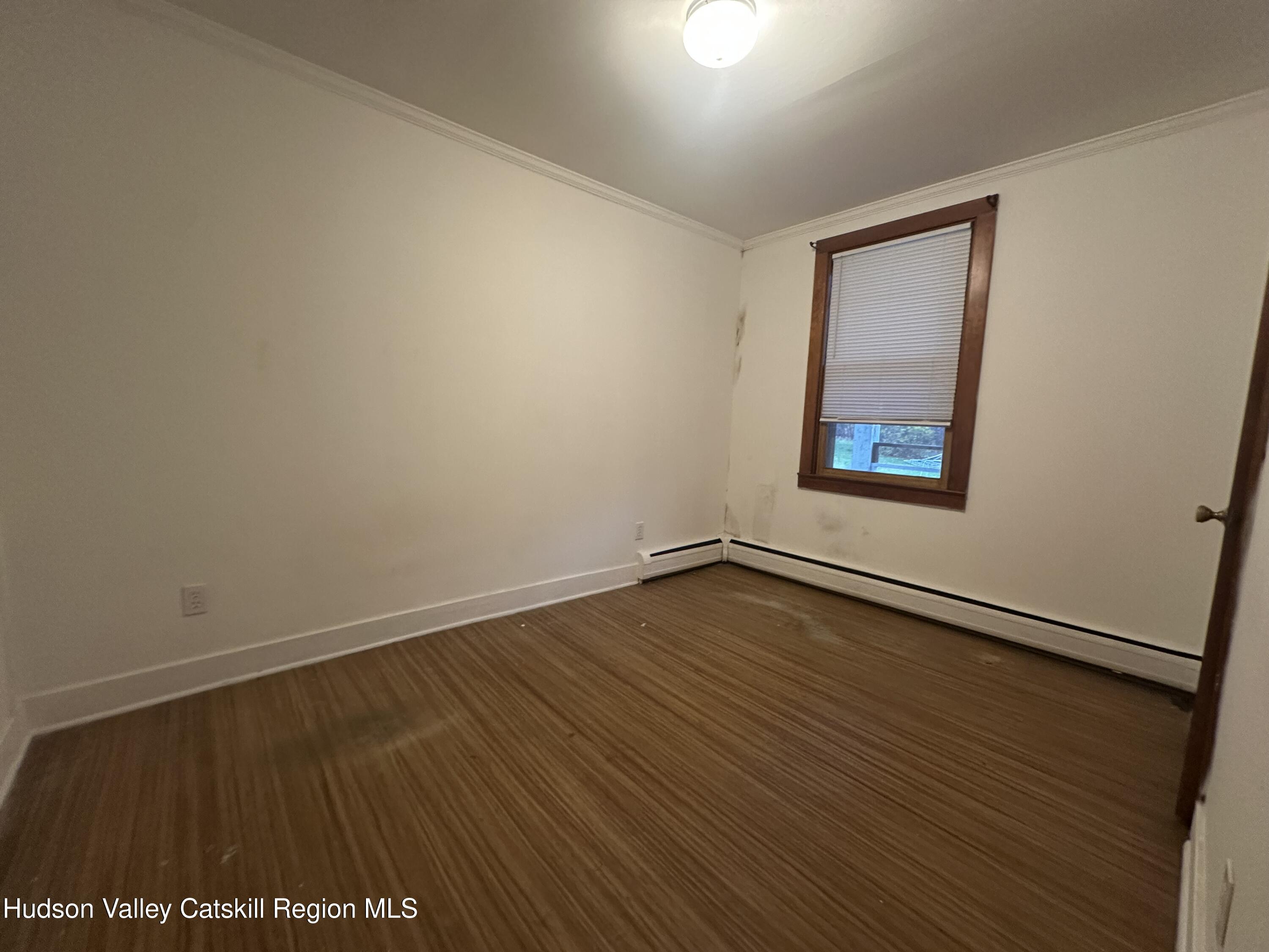 6140 Highway 9G, Unit 4 Hudson, NY 12534 - Photo 7 of 9 an empty room with wooden floor and windows