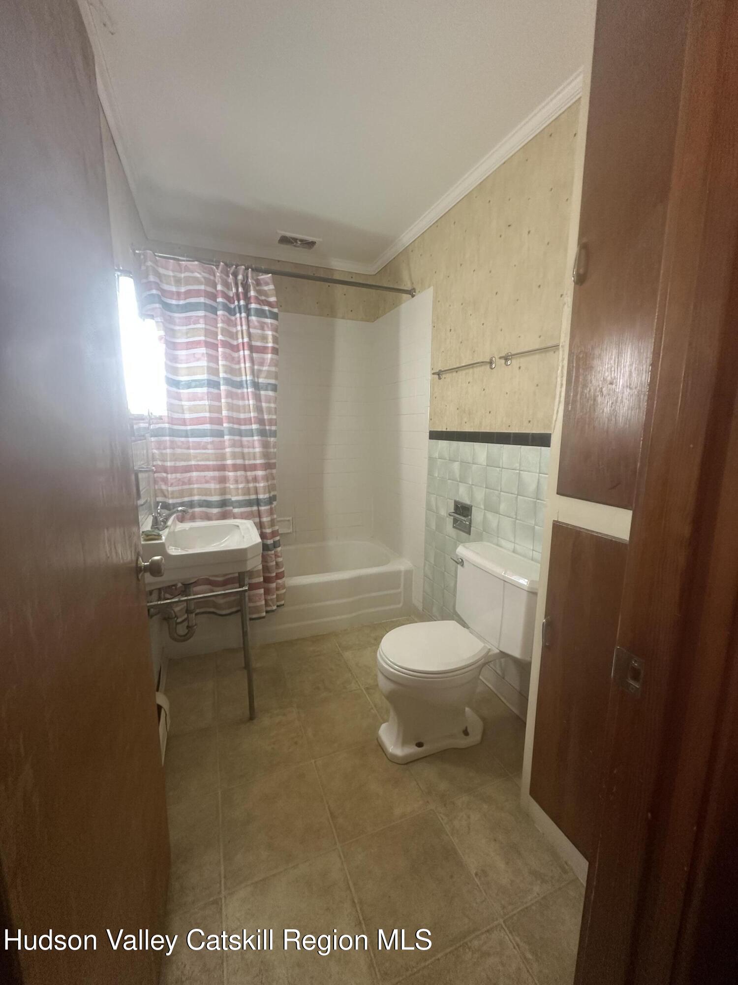 6140 Highway 9G, Unit 4 Hudson, NY 12534 - Photo 9 of 9 a bathroom with a sink a toilet and shower