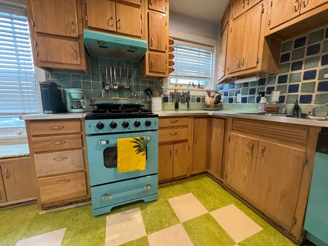a kitchen with stainless steel appliances granite countertop a stove and a sink