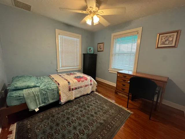 a bedroom with a bed and window
