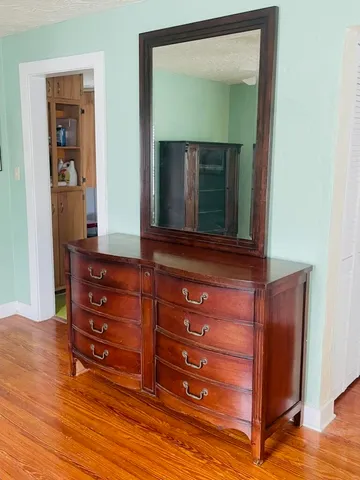 a room with a dresser and a mirror