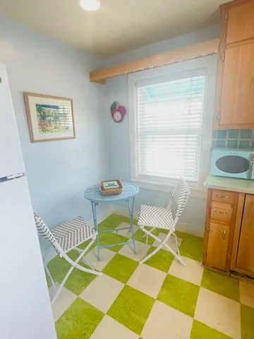 a bedroom with a rug and a window