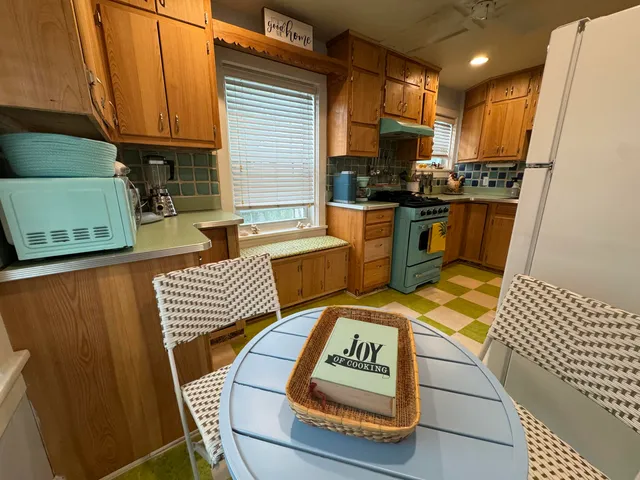 a kitchen with a sink a stove and a refrigerator