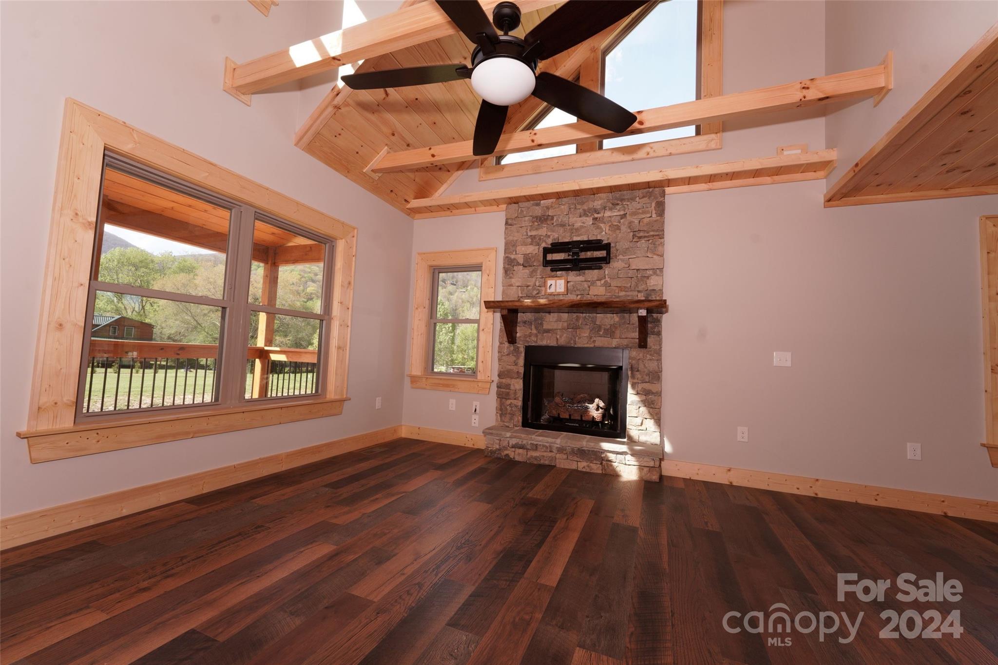 54 Alex Ridge Maggie Valley, NC 28751 - Photo 11 of 35 a view of an empty room with wooden floor and a window