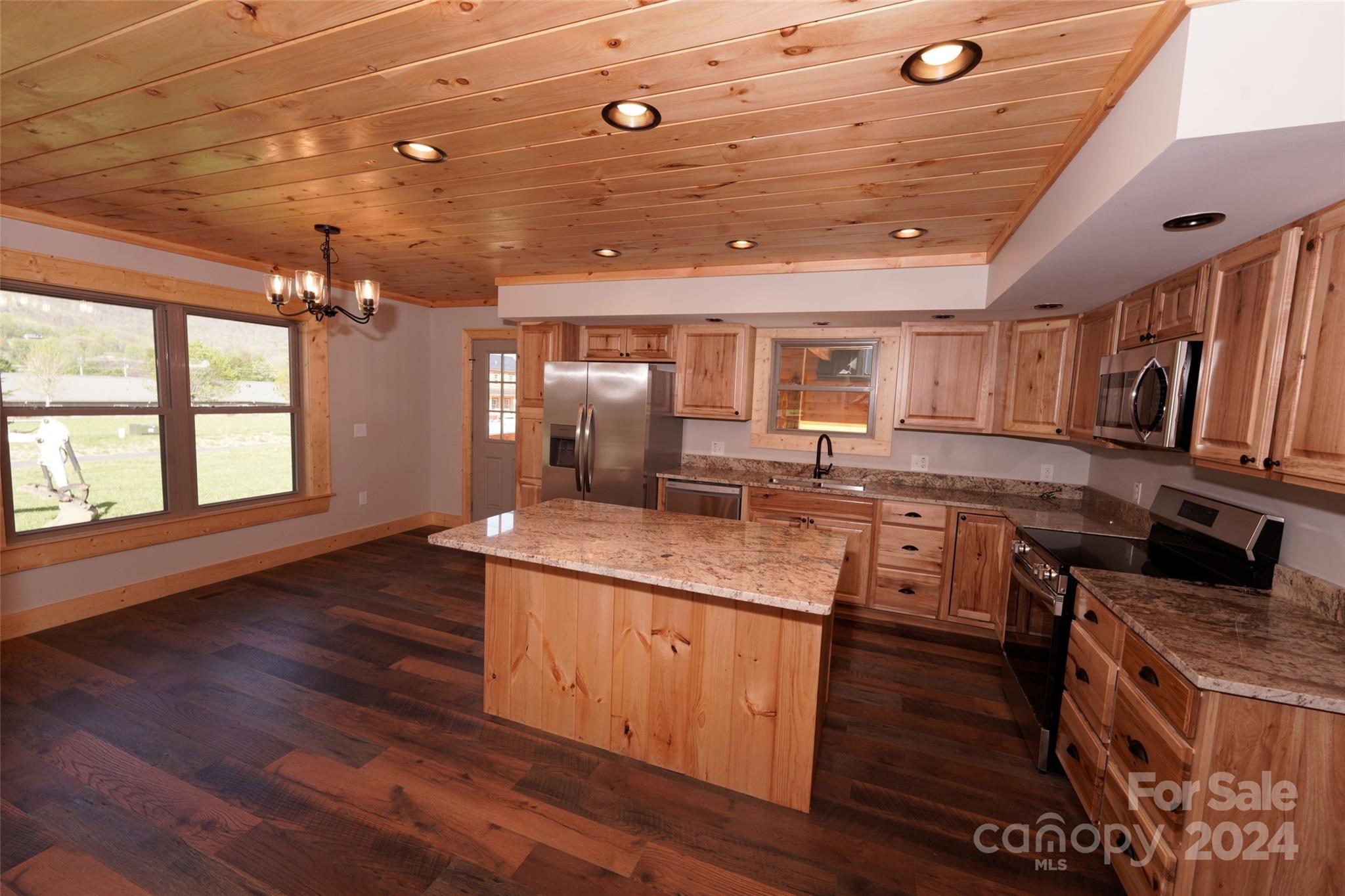 54 Alex Ridge Maggie Valley, NC 28751 - Photo 14 of 35 a kitchen with stainless steel appliances granite countertop a sink stove and wooden floor