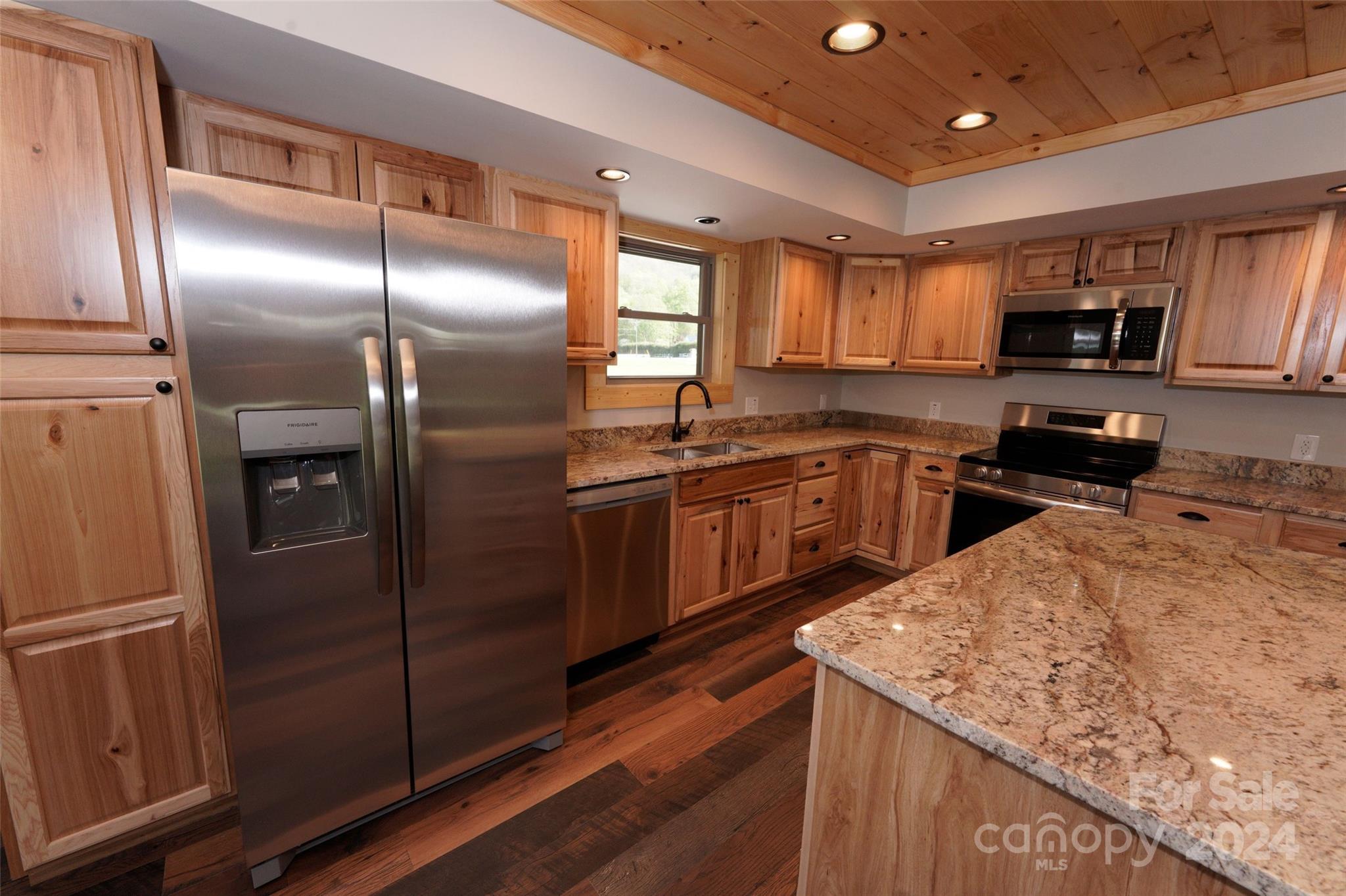 54 Alex Ridge Maggie Valley, NC 28751 - Photo 20 of 35 a kitchen with stainless steel appliances granite countertop a sink a stove and a refrigerator