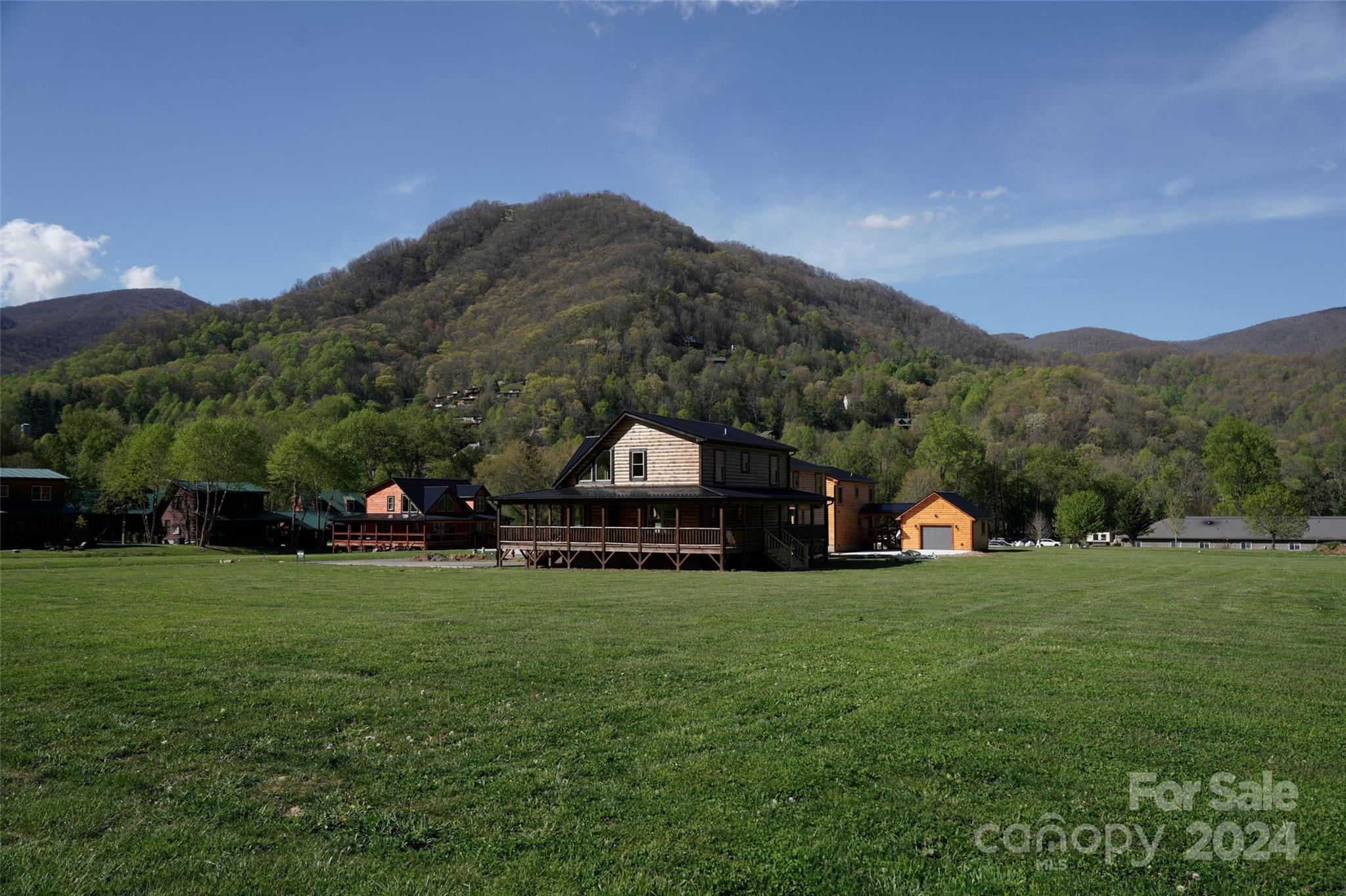 54 Alex Ridge Maggie Valley, NC 28751 - Photo 24 of 35 a view of a house with a big yard and large trees