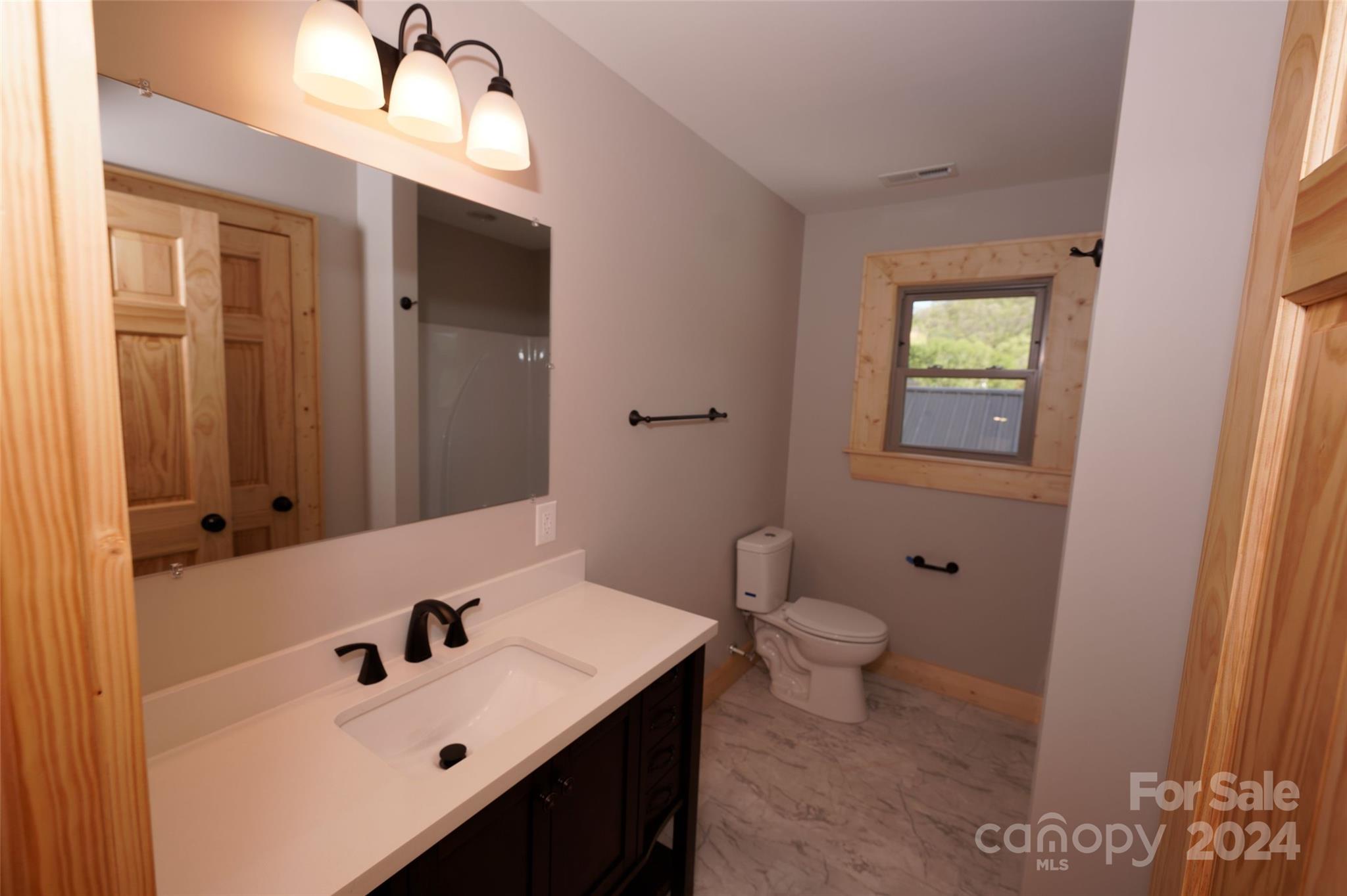 54 Alex Ridge Maggie Valley, NC 28751 - Photo 26 of 35 a bathroom with a sink a toilet and shower