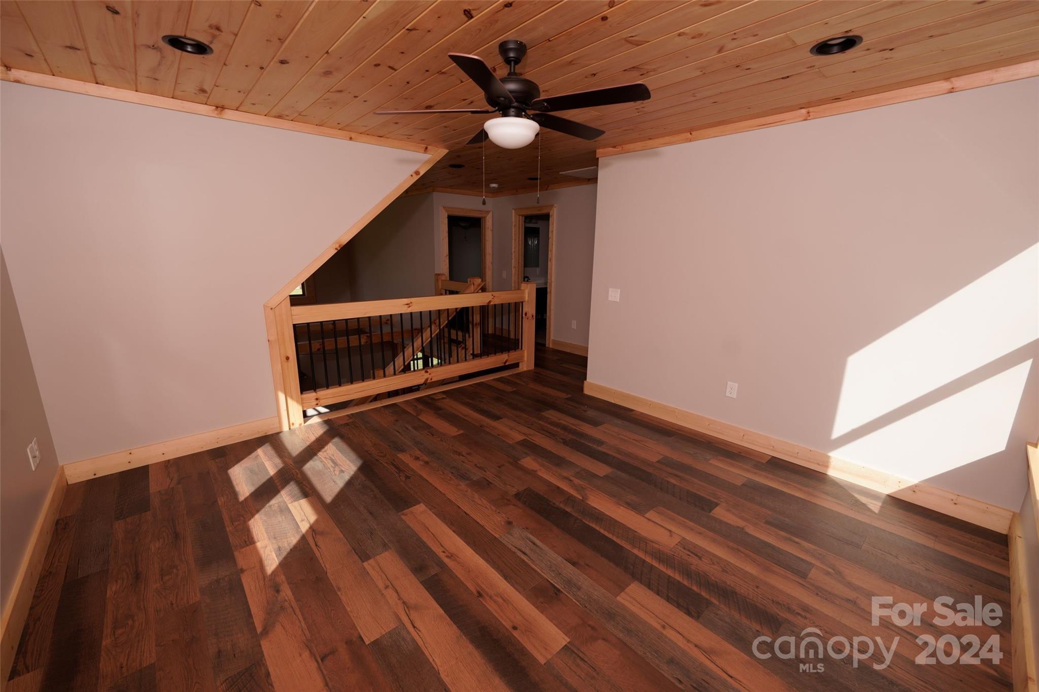 54 Alex Ridge Maggie Valley, NC 28751 - Photo 30 of 35 a living room with a bed furniture and a ceiling fan with wooden floor