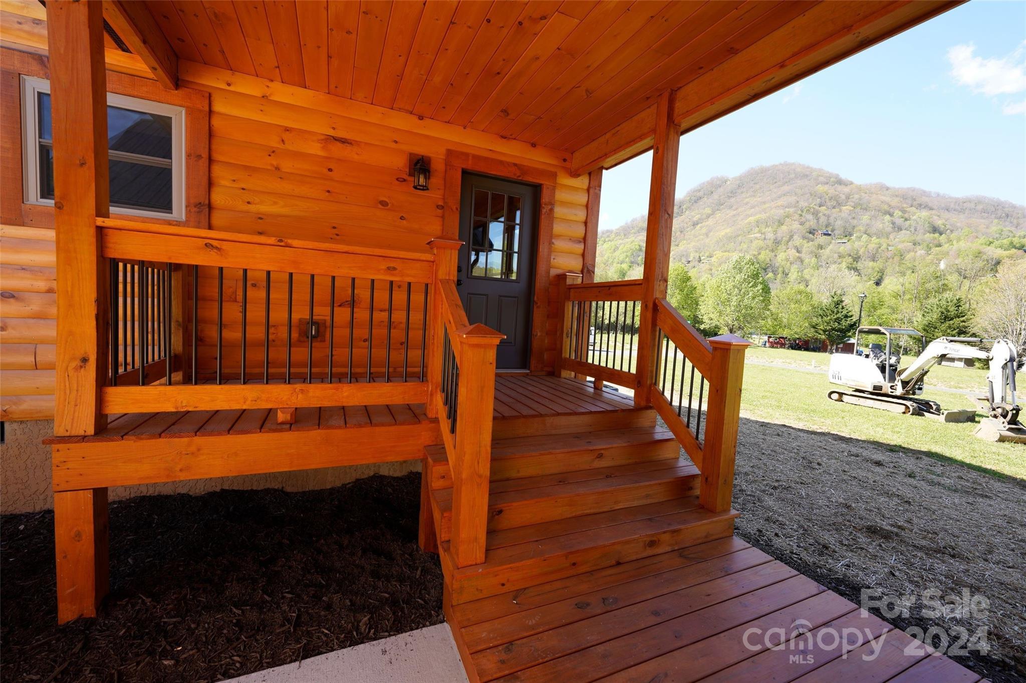 54 Alex Ridge Maggie Valley, NC 28751 - Photo 4 of 35 a view of a balcony with furniture and wooden floor