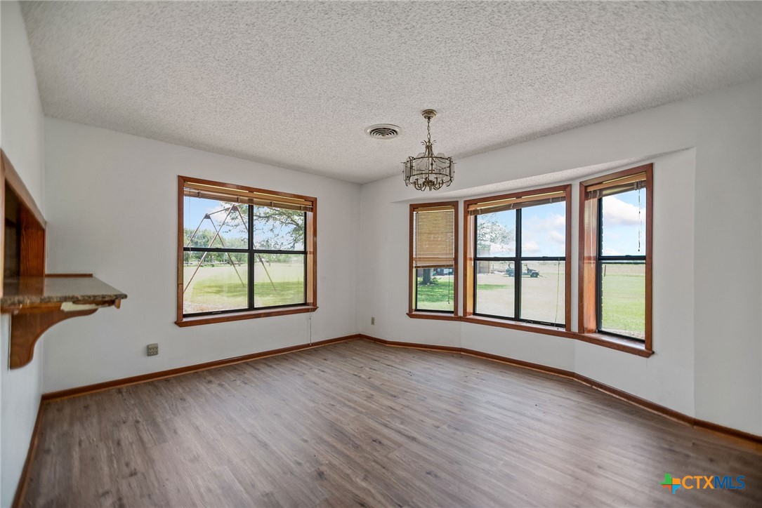 181 Pecan Street Port Lavaca, TX 77979 - Photo 6 of 34 an empty room with wooden floor and windows
